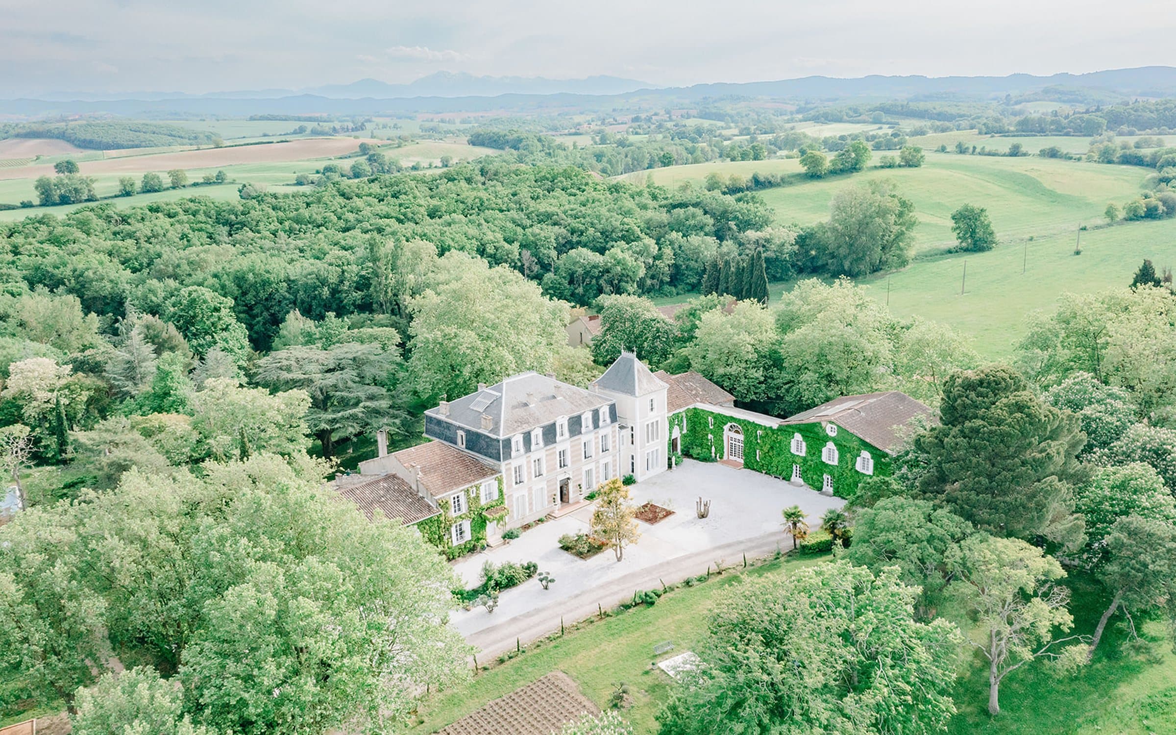 Façade du château Maison Saint Joseph entourée de jardins en Occitanie